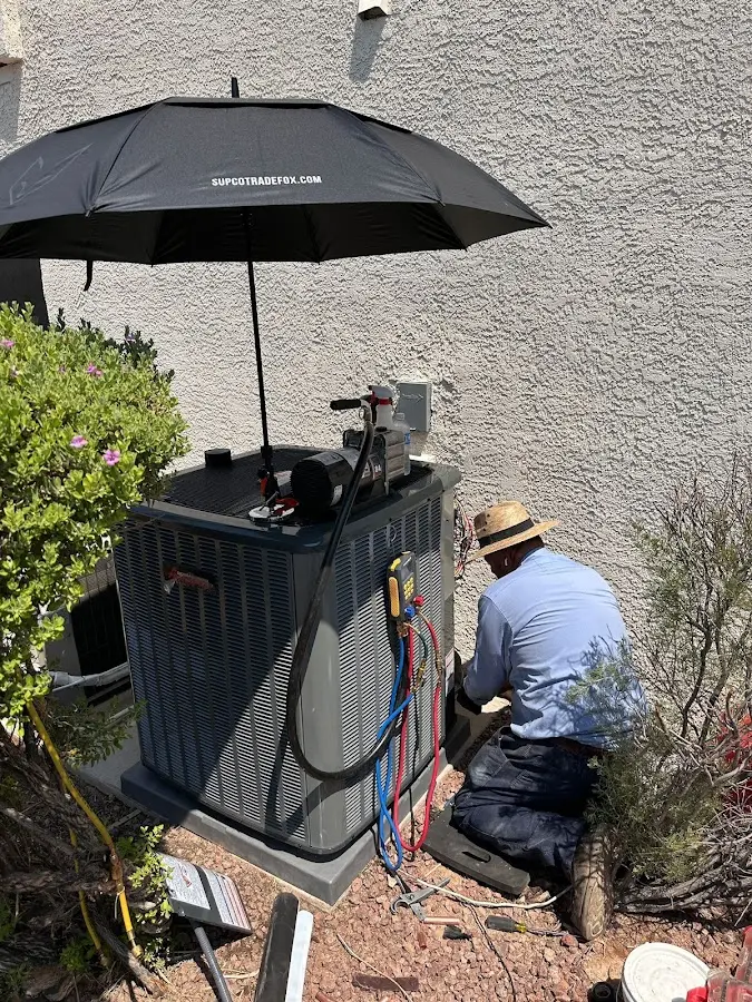 HVAC technician performing outdoor AC maintenance in Half Moon